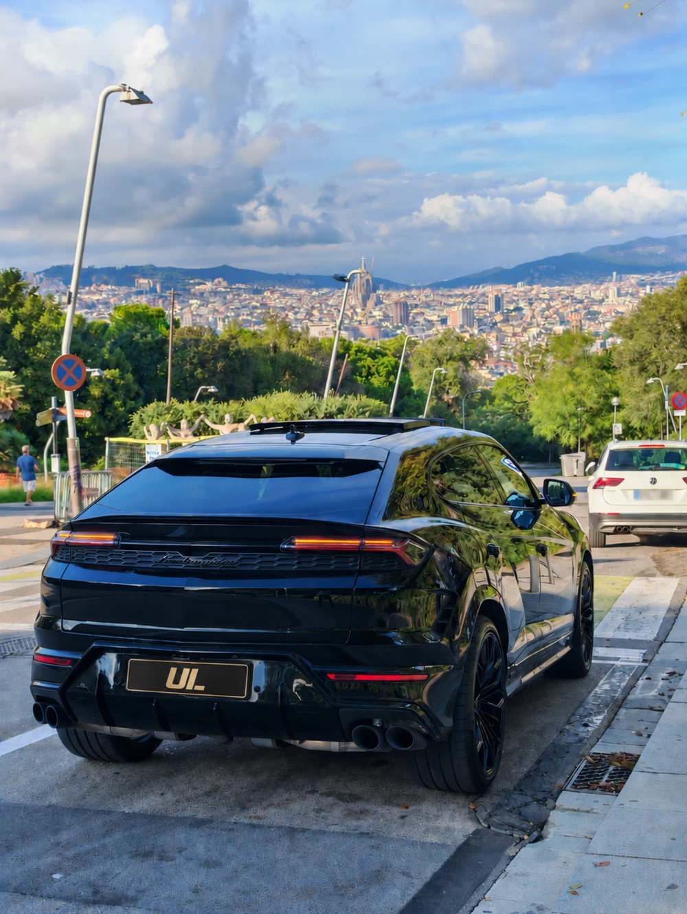 Black 2026 Lamborghini Urus in Barcelona with the city skyline in the background