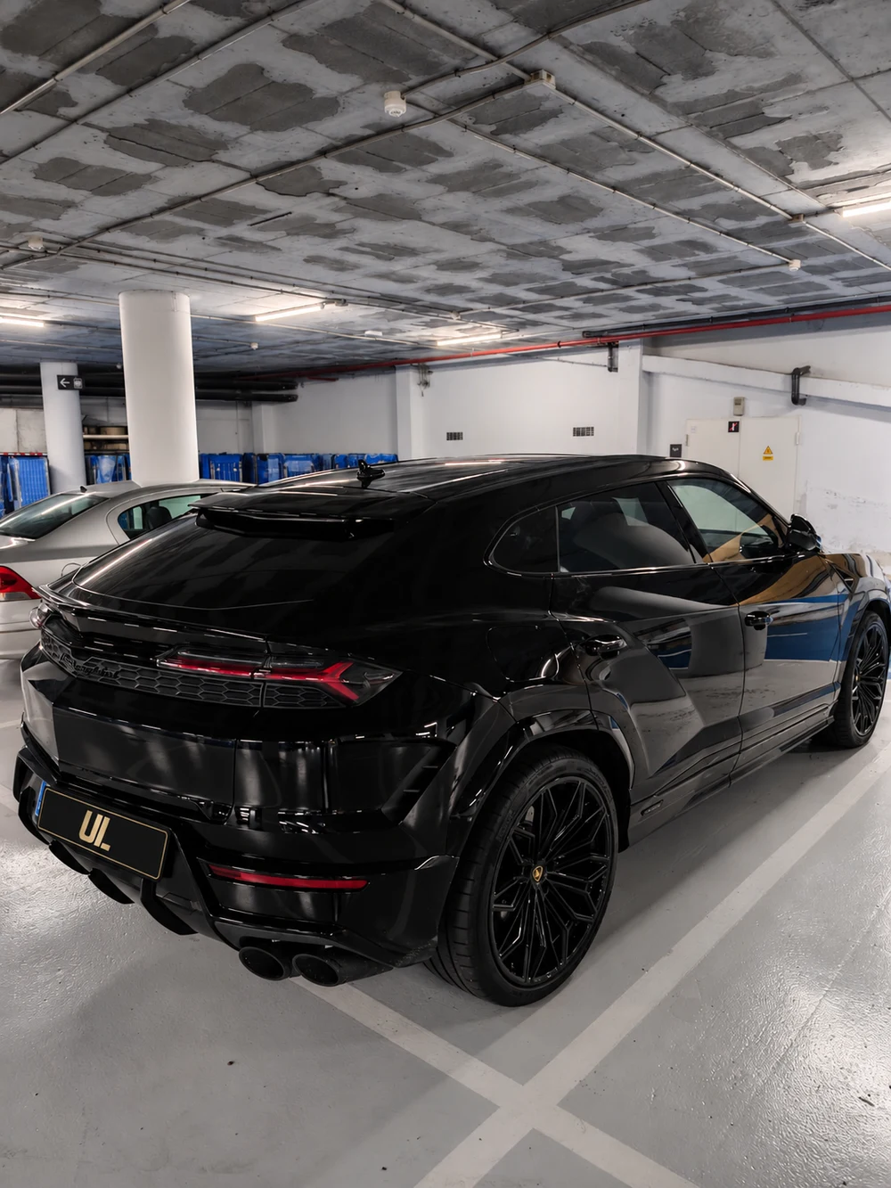Black 2026 Lamborghini Urus photographed in a parking garage during the Ultra Lux delivery