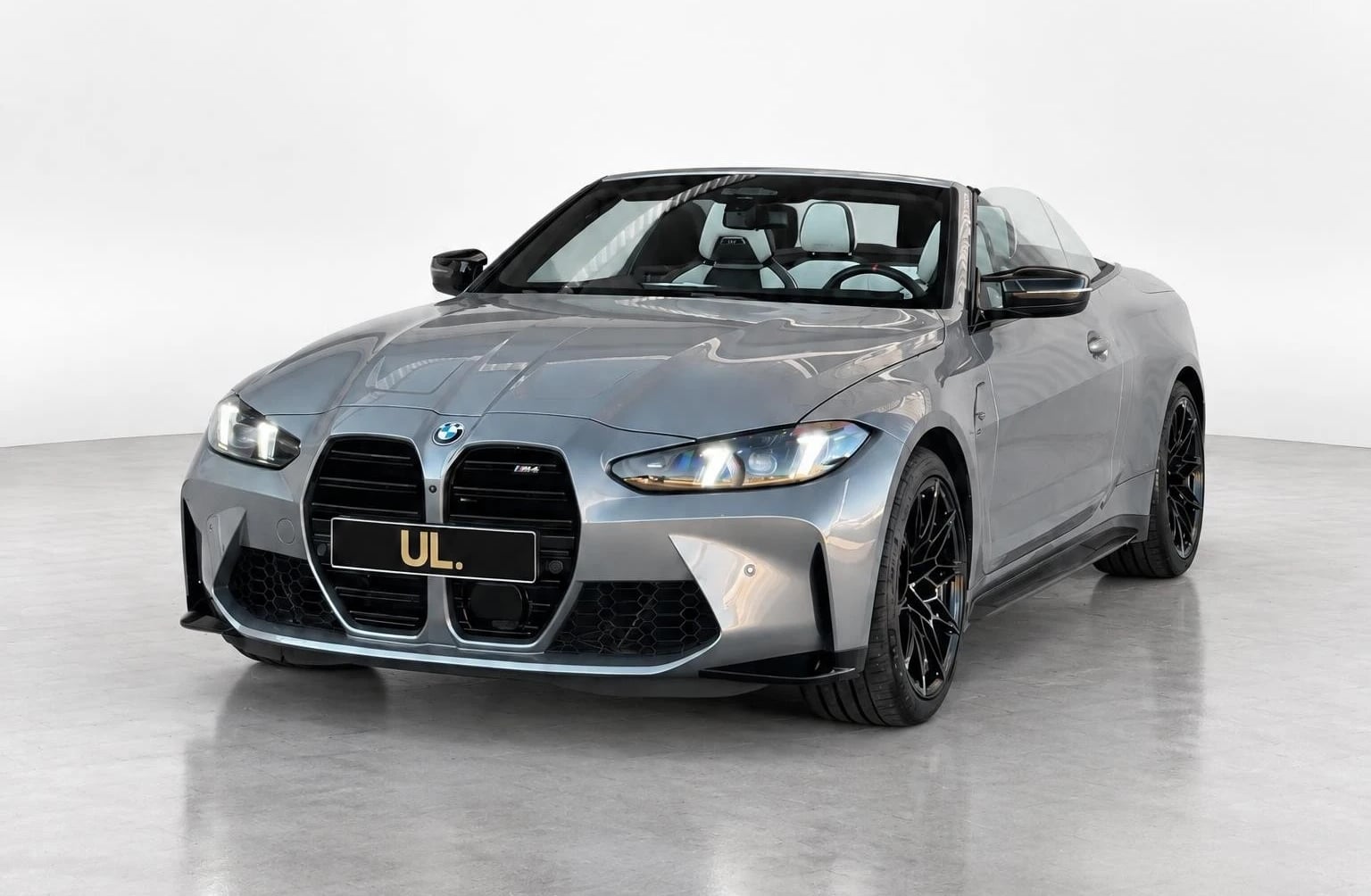 Grey BMW M4 Competition convertible in the Ultra Lux fleet with the roof open