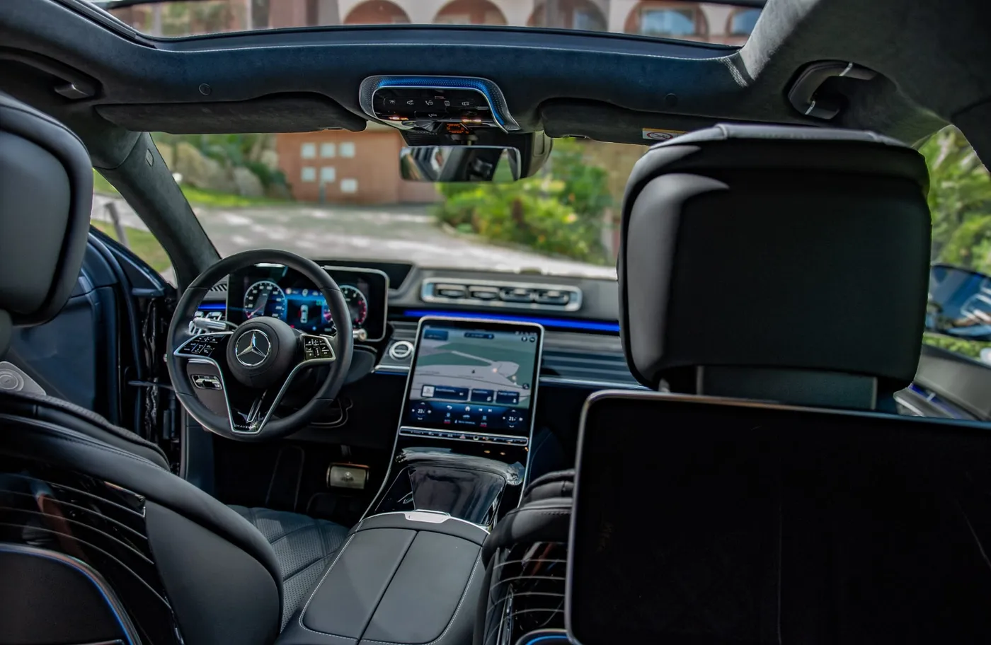 View from the rear of the Maybach S 680 towards the dashboard, rear screens and panoramic glass roof.
