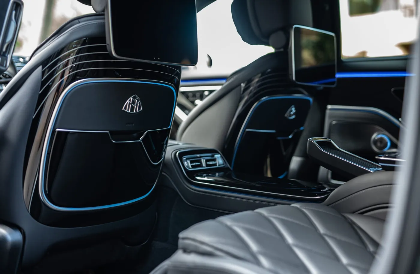 Rear screens, Maybach seat-back emblems, centre controls and blue lighting in the Mercedes-Maybach S 680.